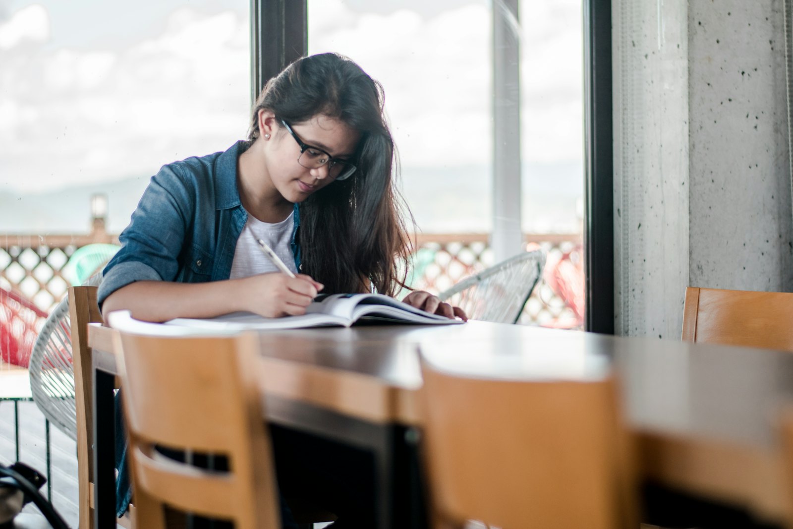 A person writing in an open notebook.
